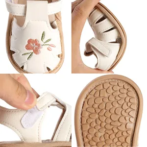 Detailed views of flexible baby girl sandals with non-slip sole and floral embroidery.