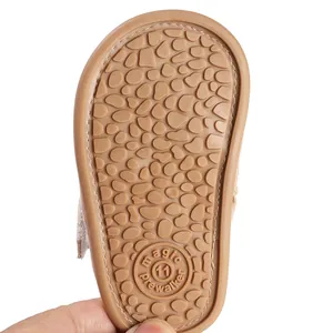 Close-up of brown anti-slip rubber sole with pebble pattern for baby girl pre-walker sandals