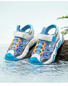 Close-up of blue children's sports sandals with breathable mesh on water background