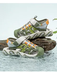 Side view of breathable green children's caged sandals on rock with water splash