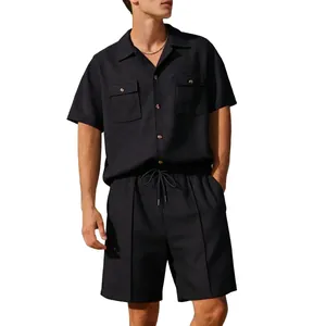 Detail view of a model wearing a black men's waffle knit shirt and matching shorts set
