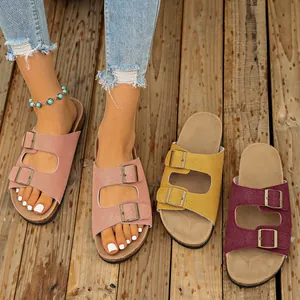 Close-up detail of stylish women's suede double-buckle sandals in multiple vibrant colors