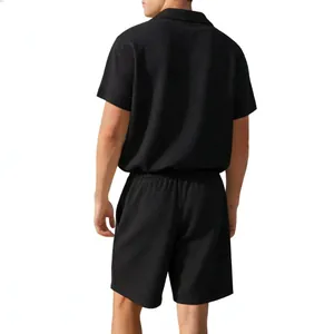 Rear view of men's black waffle knit short sleeve shirt and matching casual shorts set