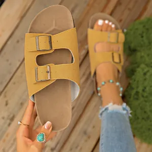 Close-up of yellow buckled sandal showing material texture and double strap design