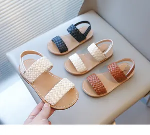 Detailed shot of girls' woven summer sandals in multiple colors including cream and brown.