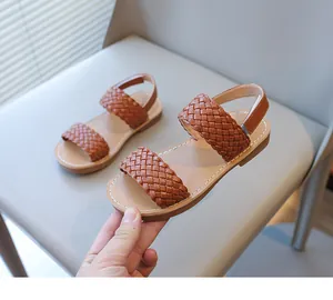 Detailed view of brown woven straps on stylish girls' summer sandals