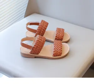 Detailed view of stylish brown woven leather sandals for girls with comfortable flat soles