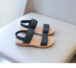 Close-up detail of black woven straps on children's fashion summer sandals