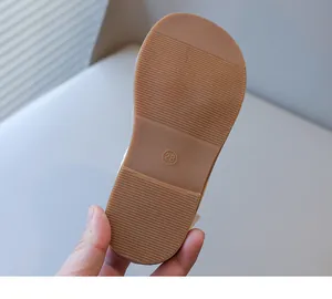 Detailed view of the non-slip brown rubber sole for children's summer beach sandals