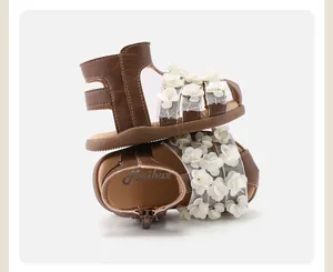 Detail view of brown toddler flower sandals with 3D floral accents and soft soles.