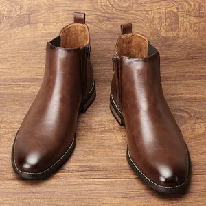 Close-up of classic brown leather Chelsea boots for men with elegant wood background