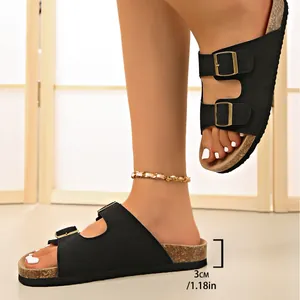 Detailed side view of black double buckle sandals showing the 3cm platform heel height