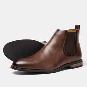 Detailed view of men's brown Chelsea boots showing leather texture and non-slip sole