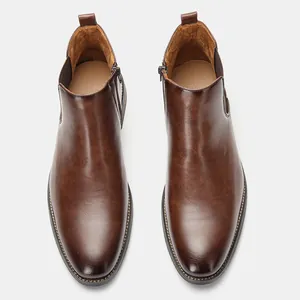 Top view of classic brown leather Chelsea boots for men with side zipper details.