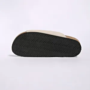 Bottom view of Birkenstock style slide sandal showing wave patterned non-slip black sole