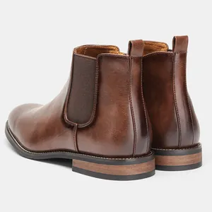 Detail view of brown leather Chelsea boots for men with elastic side panels and heel tab