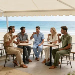 Detail of men's linen short sleeve shirt and trousers set worn by a group at a beach
