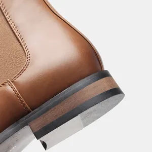 Macro view of the high-quality brown leather and textured heel of a men's Chelsea boot