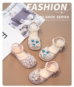 Detail of sparkly girls princess sandals with rhinestone flowers and pearl straps
