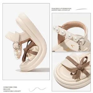 Elegant beige girl's princess sandals with decorative pearl strap and bow detail for summer