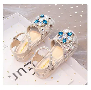 Detail view of girls princess sandals with blue crystal flower and pearl straps