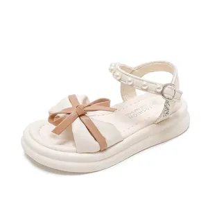 Elegant white girls princess sandals featuring pearl ankle straps and bicolor leather bow