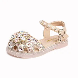 Elegant sparkly girls' princess sandals featuring a rhinestone flower and pearl ankle strap