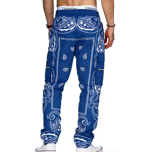 Detail view of men's blue paisley cargo pants with multi-pockets and tapered fit.