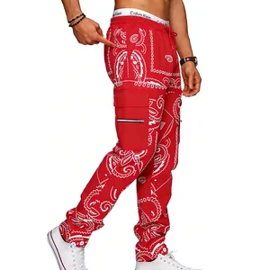 Side detail of red paisley cargo pants featuring multi-pockets and white bandana print