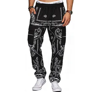 Close-up view of men's black paisley print cargo pants featuring multiple functional pockets