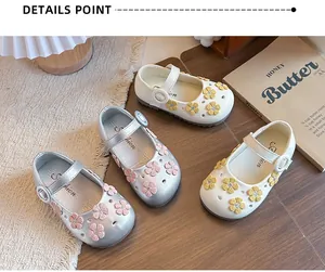 Detail view of girls floral Mary Jane shoes in silver and white with flower appliques