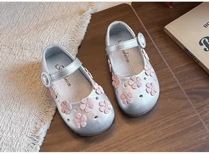 Detailed view of silver girls' Mary Jane shoes featuring pink embroidered flowers and a strap