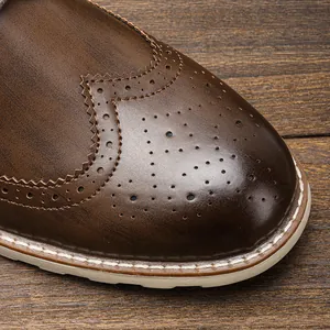 Close-up of vintage brown leather Brogue shoe detailing with classic wingtip perforations