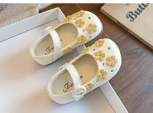 Close-up of girls' Mary Jane shoes with yellow flower embroidery and soft leather.