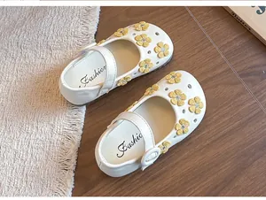 Top view of white girl's Mary Jane princess shoes featuring yellow embroidered flowers