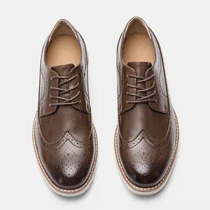 Top-down view of men's classic brown leather Brogue shoes featuring wingtip perforation
