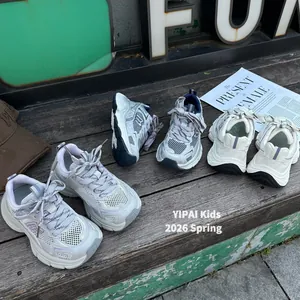 Breathable kids' chunky sneakers in multiple spring colors displayed on a wooden bench.