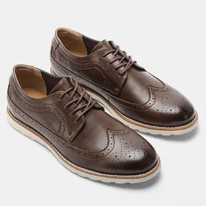 Close-up macro view of brown leather brogue shoes with intricate perforated wingtip details