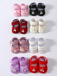 Detailed view of various colorful infant lace princess shoes decorated with pearl bows