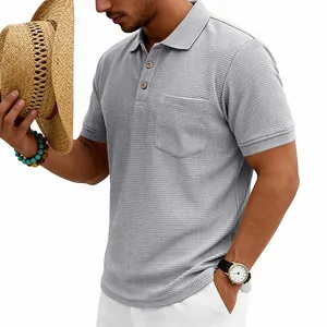 Men's grey waffle knit polo shirt featuring a chest pocket and textured fabric details.