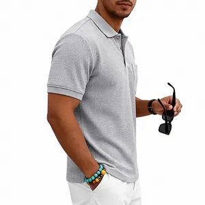 Detail view of men's grey waffle-knit polo shirt showing heavy texture and chest pocket