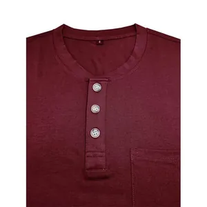 Close-up detail of a men's burgundy Henley shirt with buttons and front pocket