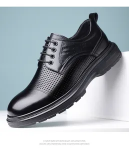 Macro view of black leather business dress shoes featuring elegant perforated patterns