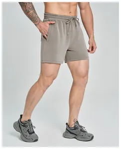 Close-up of men's breathable taupe modal sports shorts featuring drawstring waist and pockets