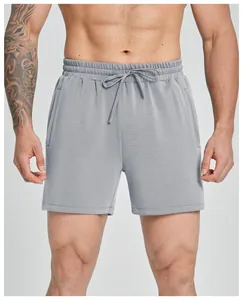 Close-up view of grey modal men's fitness shorts featuring drawstring and side pockets