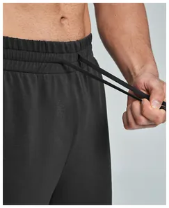 Detail view of adjustable drawstring waistband on black modal men's sports joggers