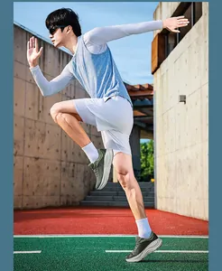 Side view action shot of lightweight carbon plate running shoes on an outdoor sports track