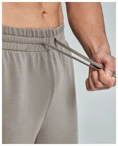Macro detail of men's modal sports trousers showing elastic waistband and drawstring
