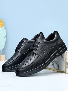 Detailed macro view of black perforated leather men's business casual shoes