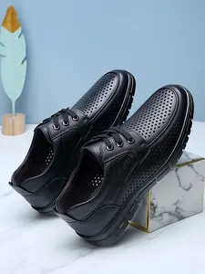 Side detail of black perforated leather business casual shoes for men